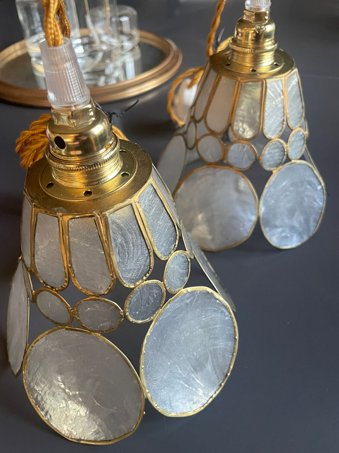 Pair of portable lamps with mother-of-pearl lampshades and brass.