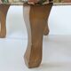 Large vintage upholstered footstool with curved legs.