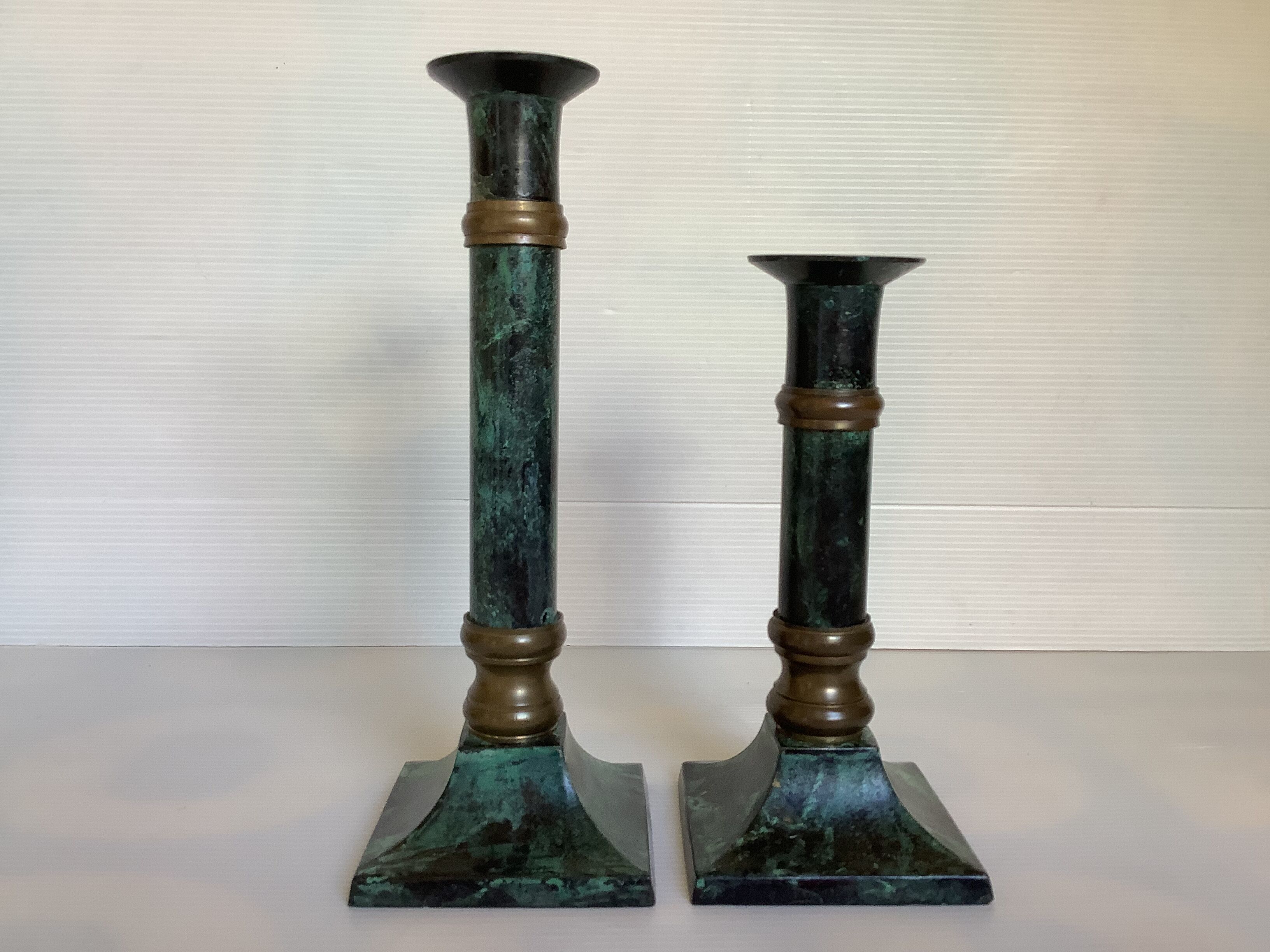 Pair of green patinated brass candlesticks
