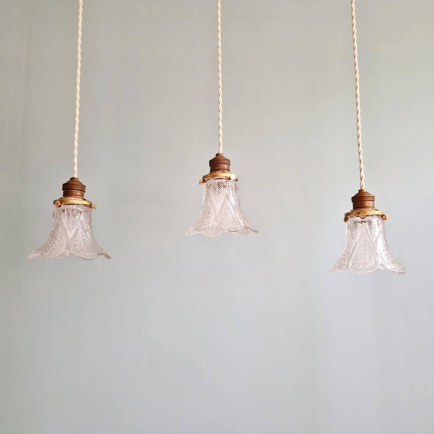 Art Deco trio of pendant lights/table lamps in clear glass, 1920s-30s.
