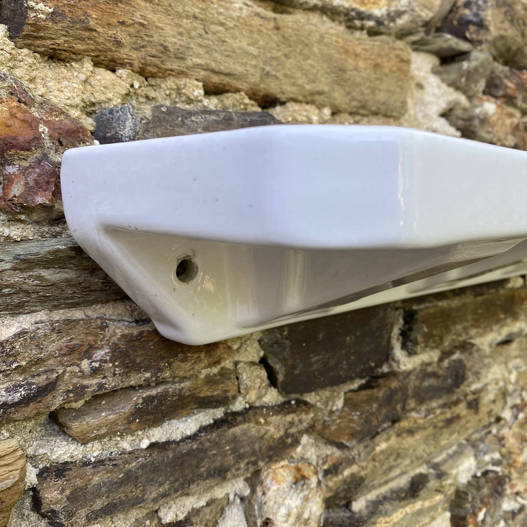 Antique wall shelf for bathroom in white porcelain.