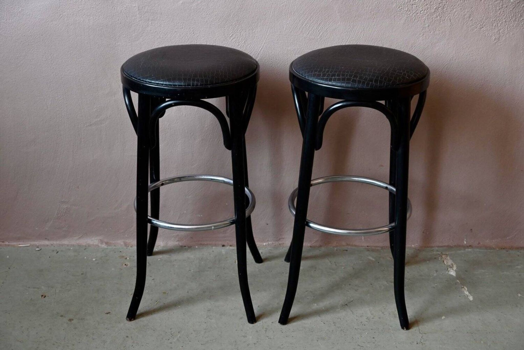 Pair of 1960s bistro bar stools in black and chrome with vinyl shell.