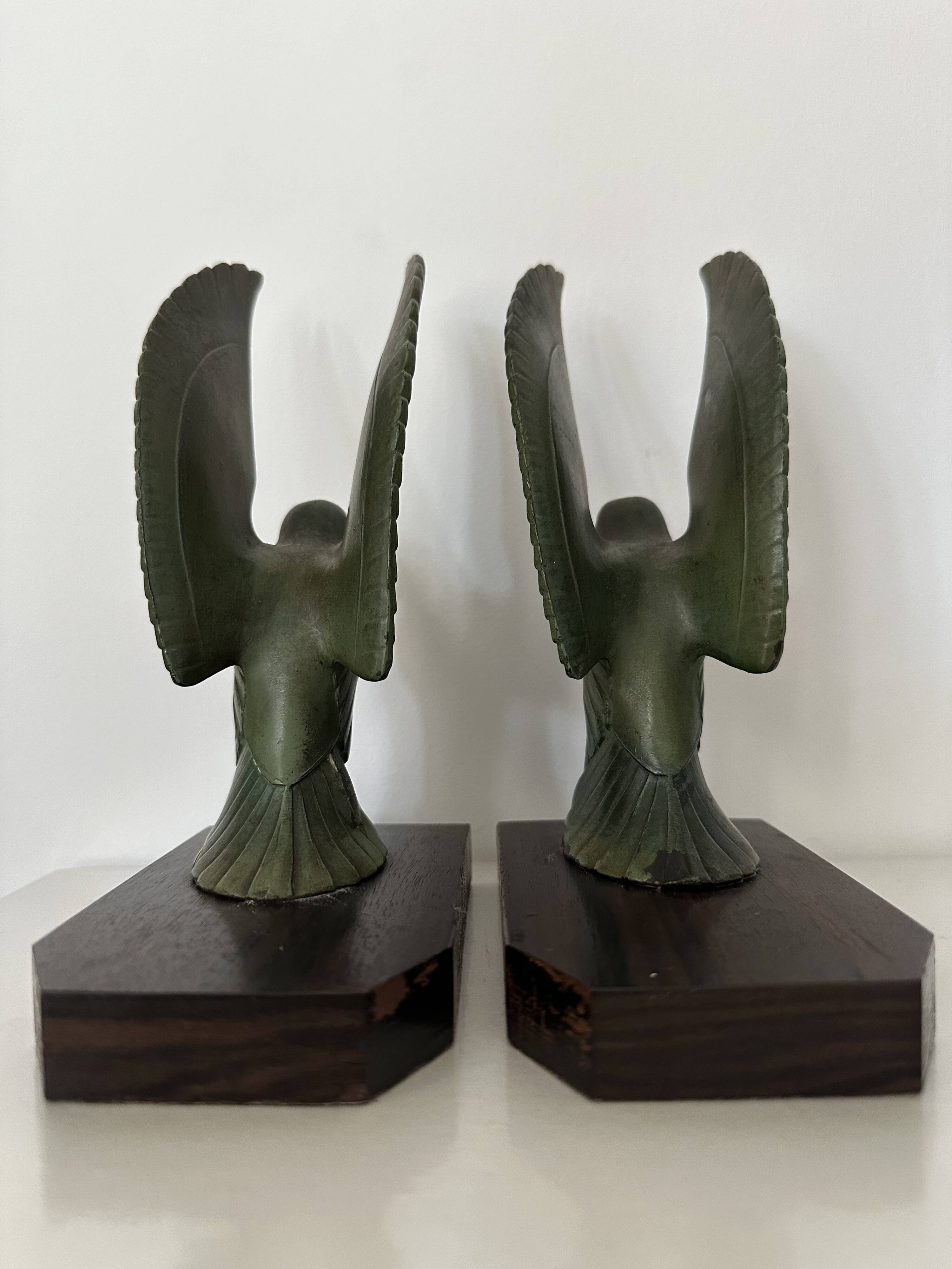 Pair of eagle bookends in green patina regula with rosewood base