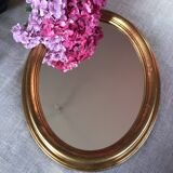 Golden oval mirror