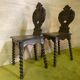 Duo of carved wooden chairs