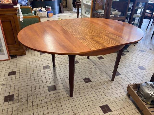 Round wooden table with integrated extensions