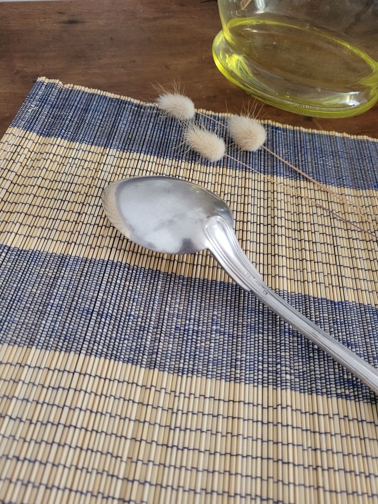 Large silver spoon with net decoration.