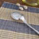 Large silver spoon with net decoration.
