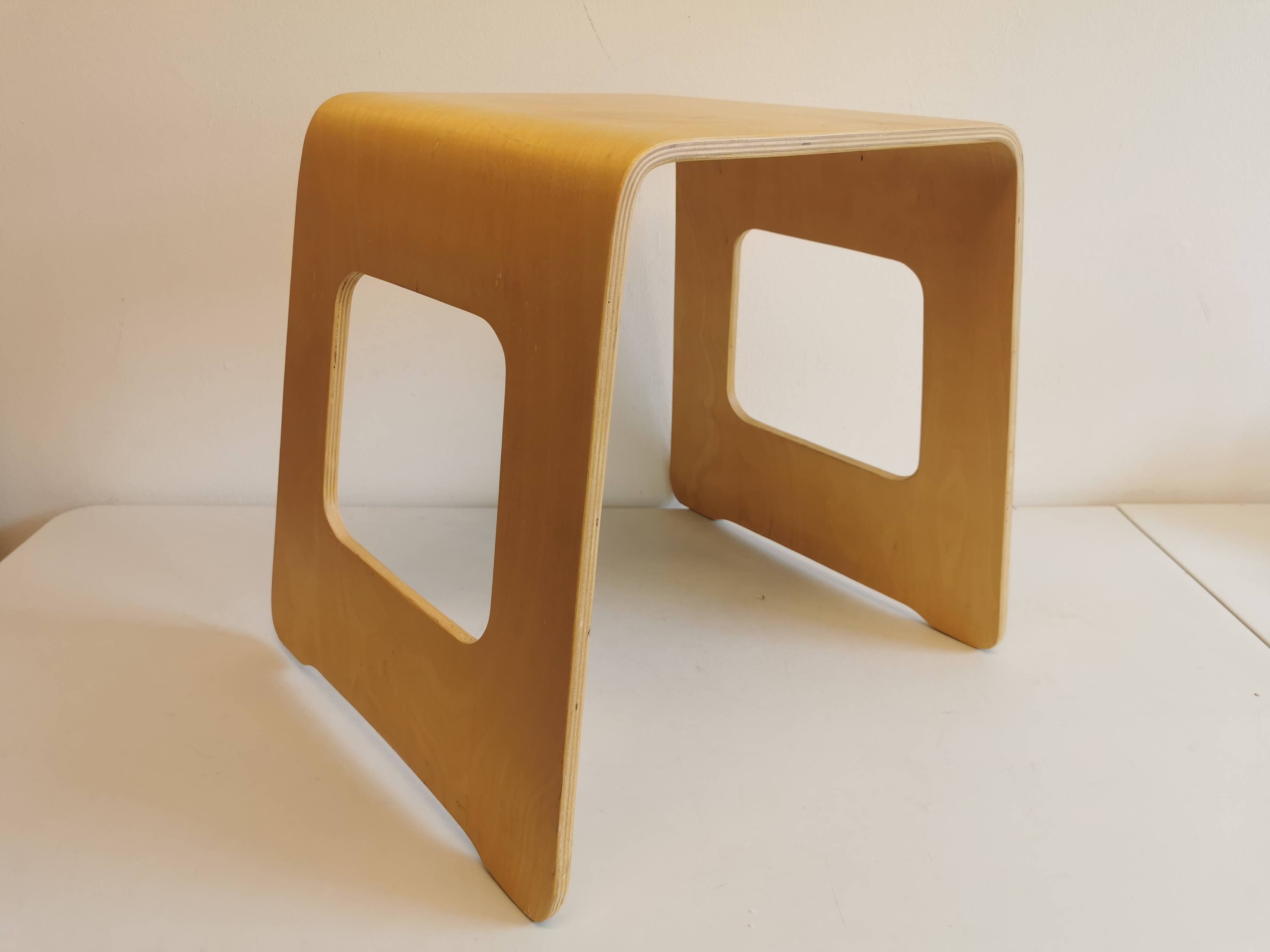 Design stool/side table made of curved plywood.