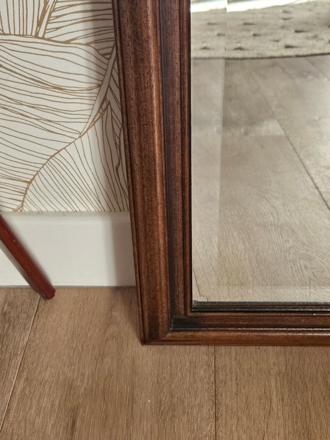 Beveled glass mirror in its wooden frame