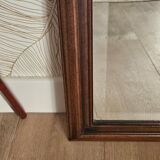 Beveled glass mirror in its wooden frame