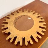 Old large golden sun mirror with rounded witch's eye in vintage resin from the 70s