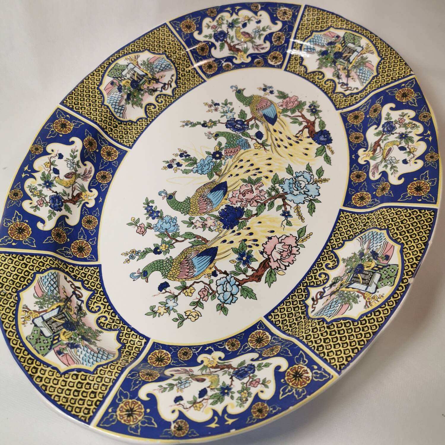 Ceramic dish decorated with peacock folk art Asian motif