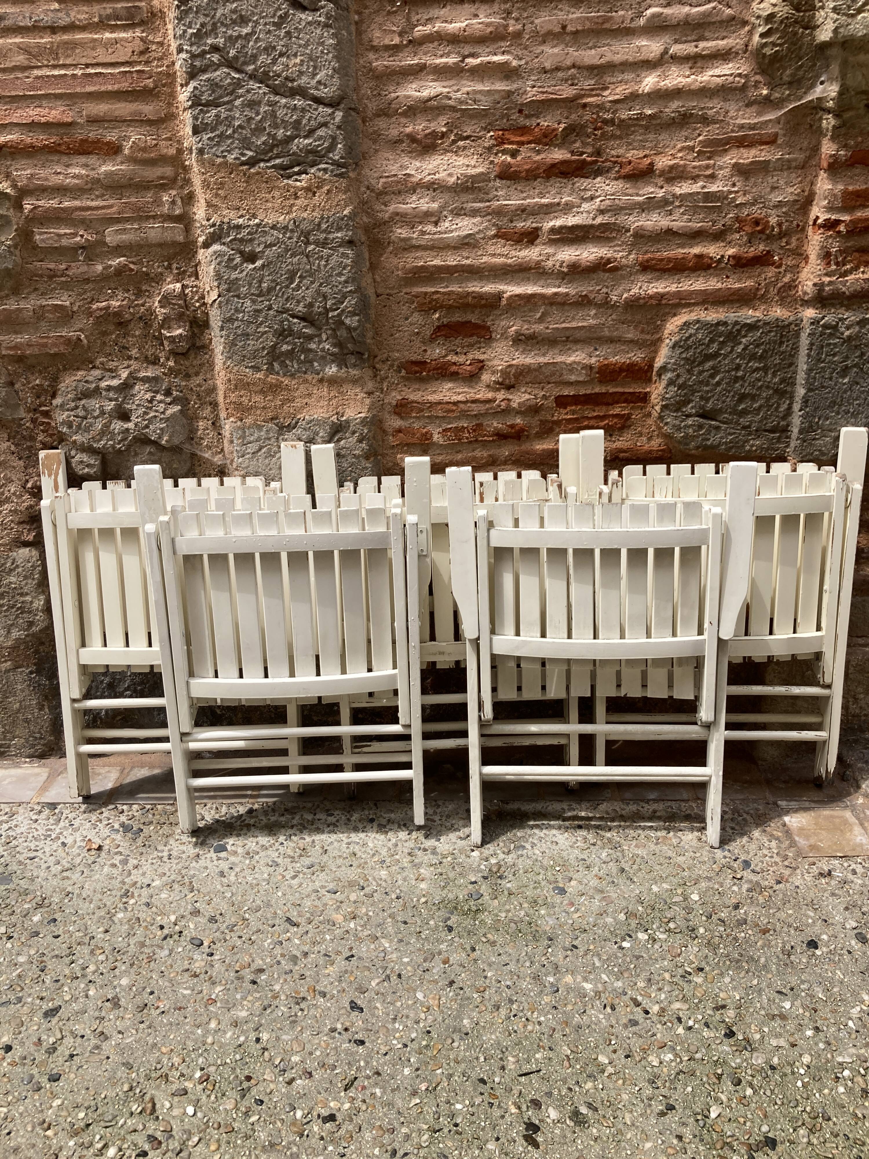 Five wooden garden armchairs