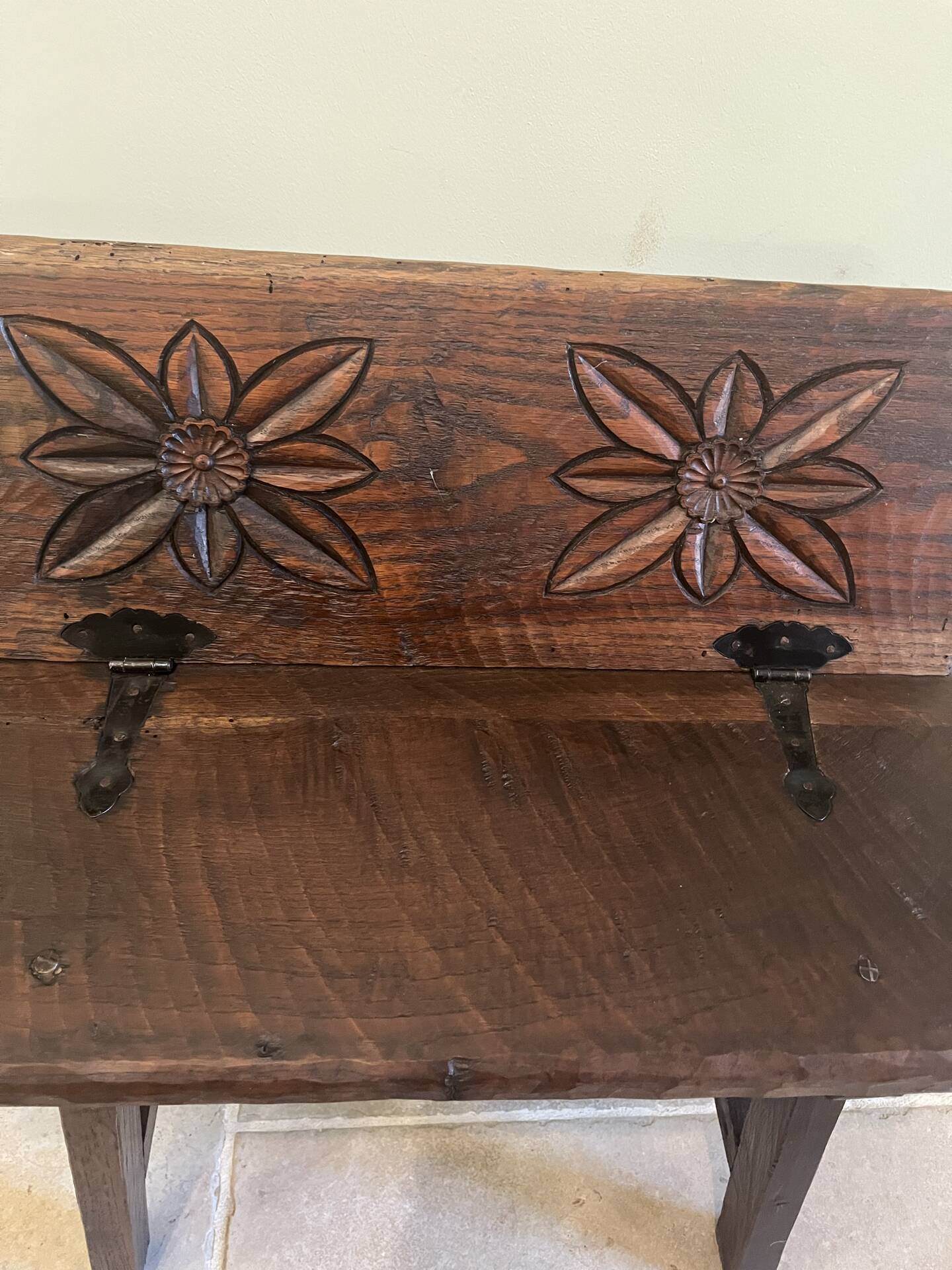 Small antique wooden bench with a folding backrest.