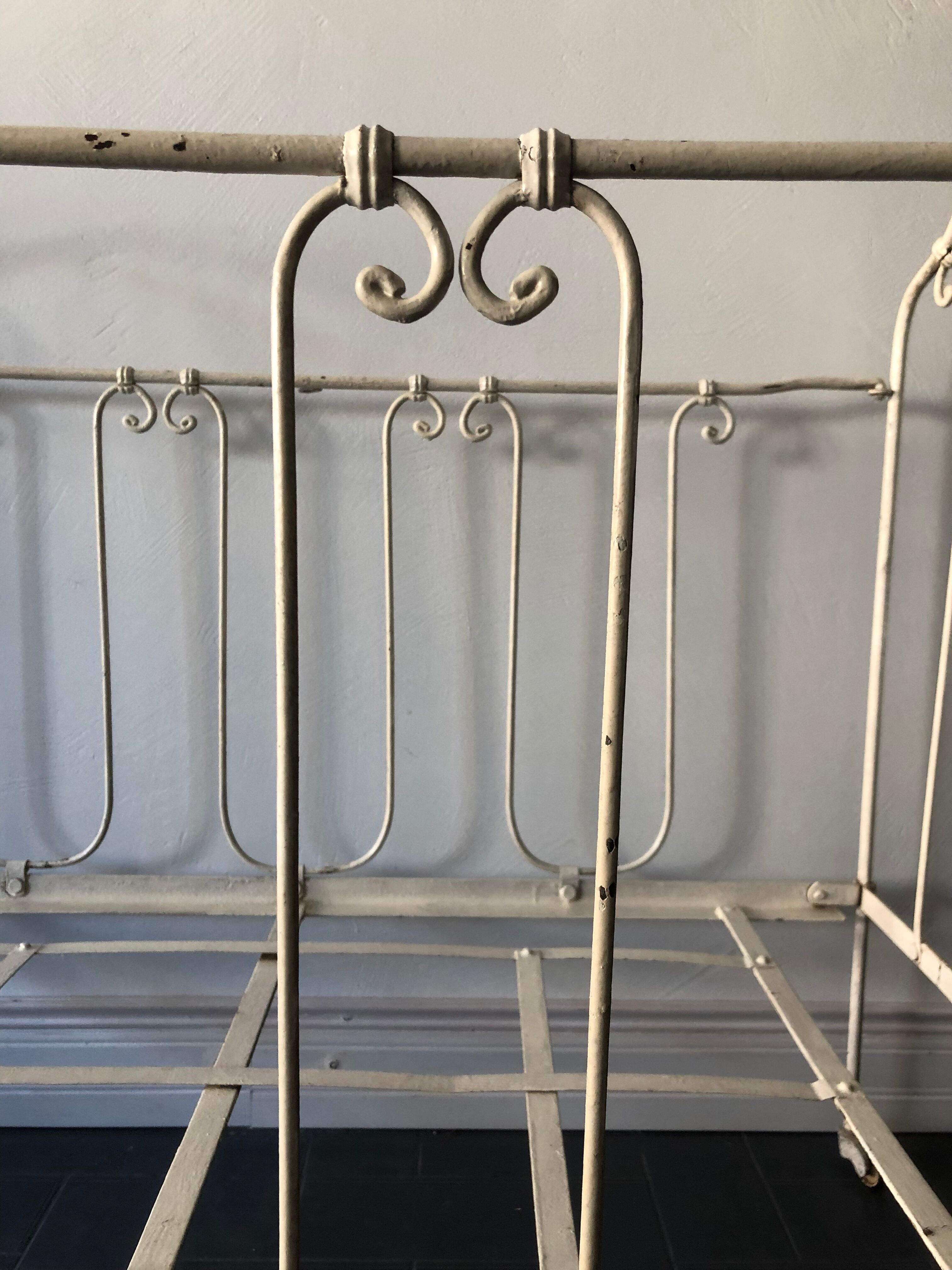 Old white wrought iron folding bed / seat