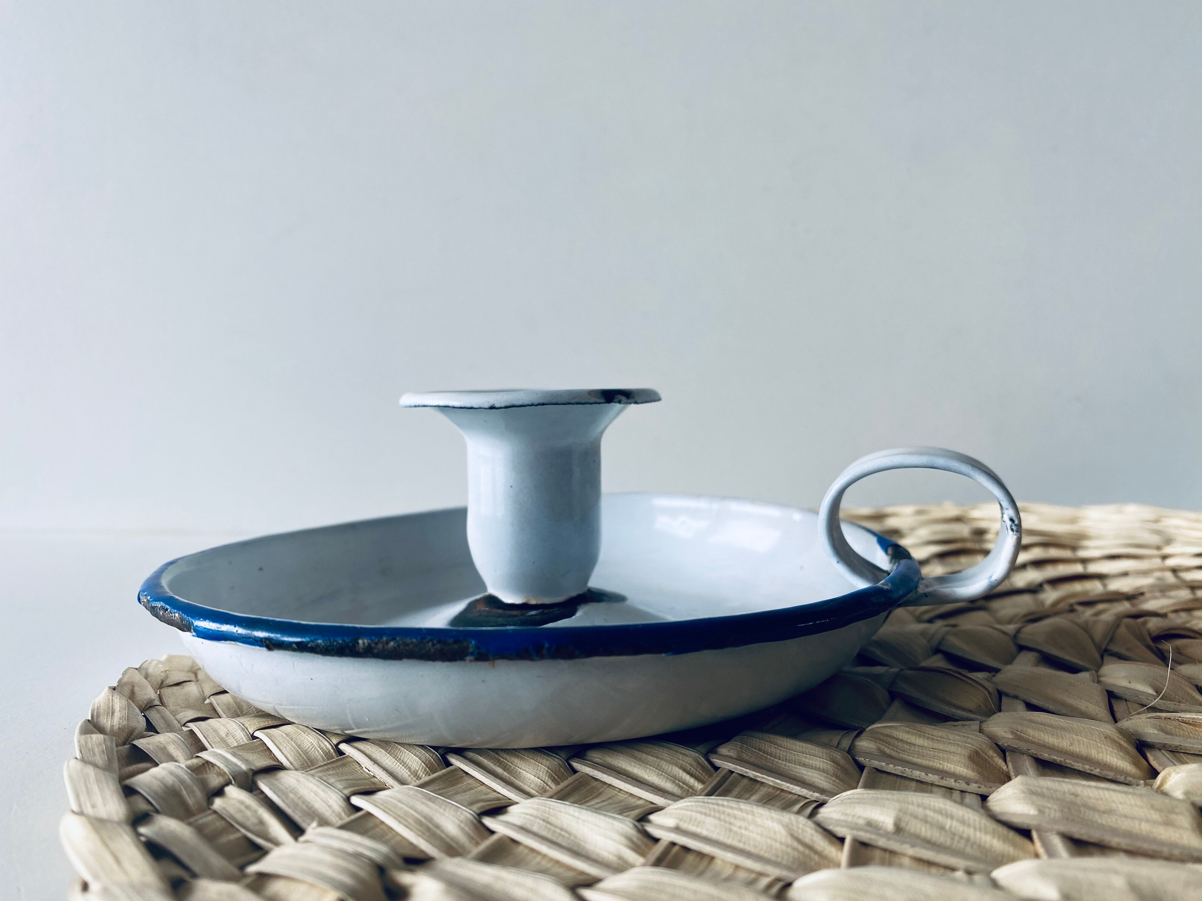 Old enamelled metal candlestick