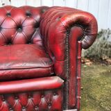 Pair of red leather chesterfield chairs