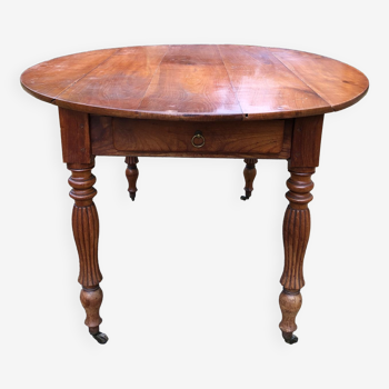 Louis Philippe oval shuttered table in solid cherry wood with 2 drawers.