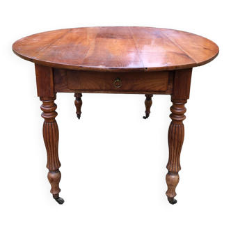 Louis Philippe oval shuttered table in solid cherry wood with 2 drawers.