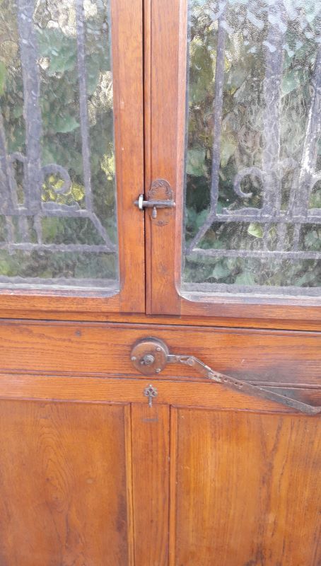 Oak entrance door and its frame and transom, wrought iron gates
