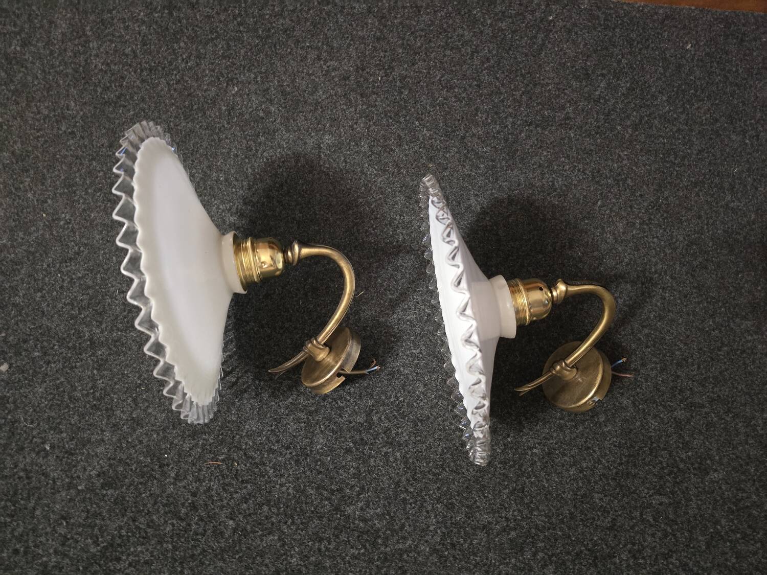Wall sconces with scalloped opaline lampshades.