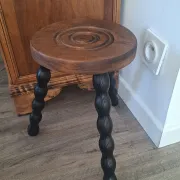 Brown and black wooden tripod stool