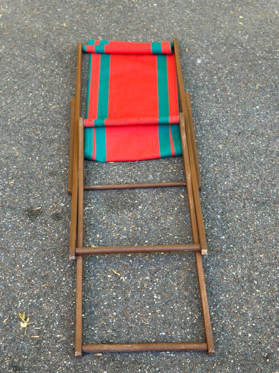 Vintage folding wooden deck chair with red and green striped canvas from the 1970s.