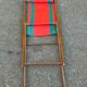 Vintage folding wooden deck chair with red and green striped canvas from the 1970s.