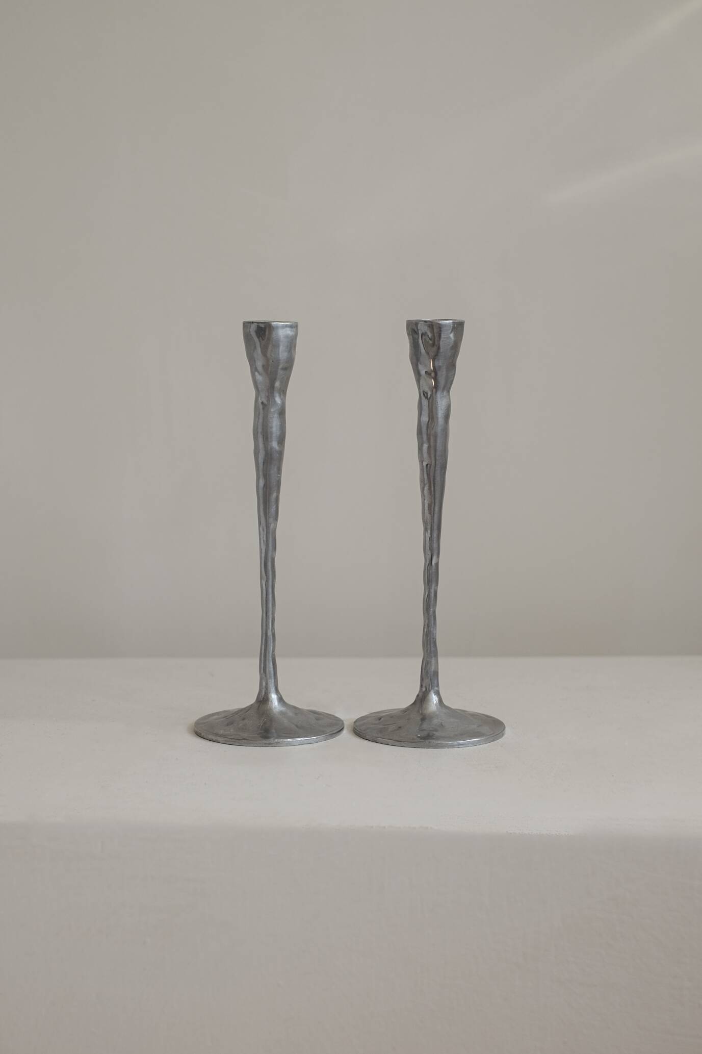Pair of aluminium candle holders