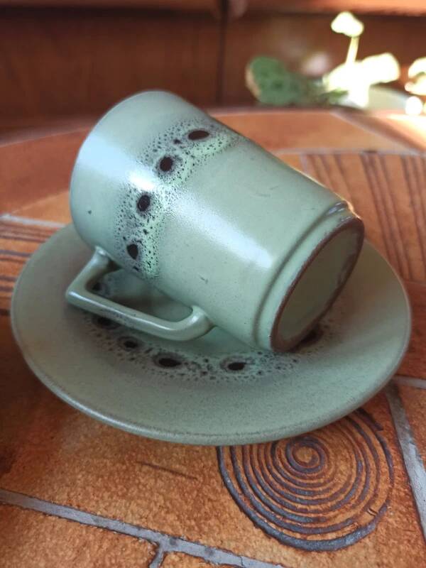 A pair of vintage glazed stoneware cups and saucers.