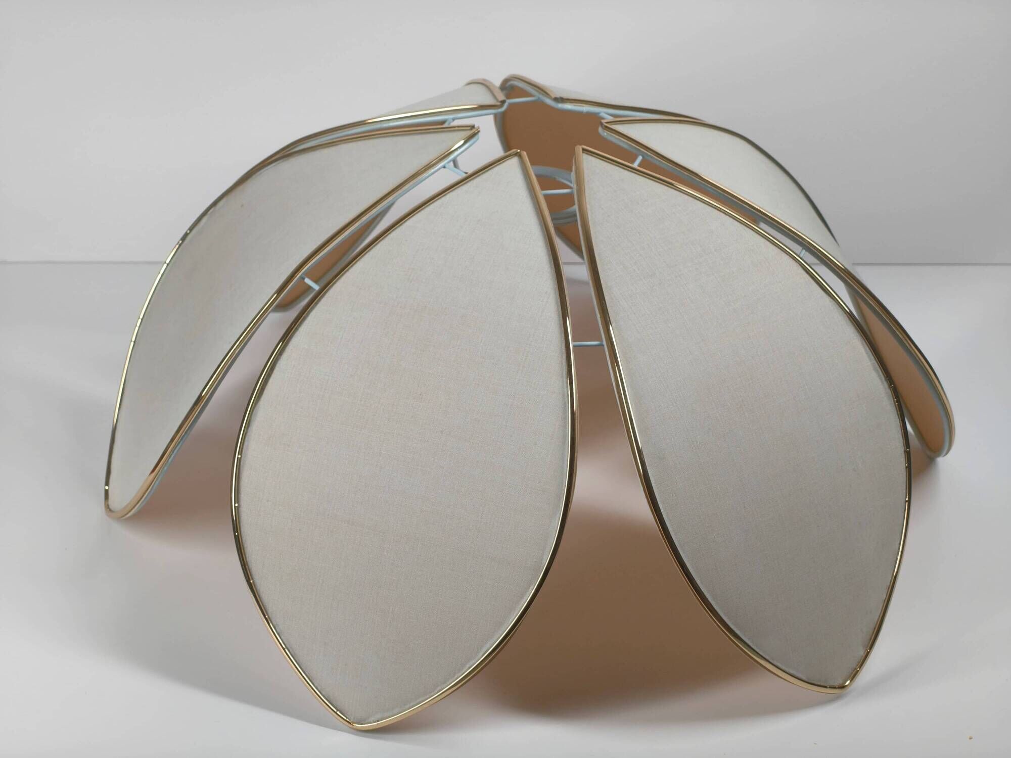 1970s ceiling light with floral design, light beige shade with gold finish.