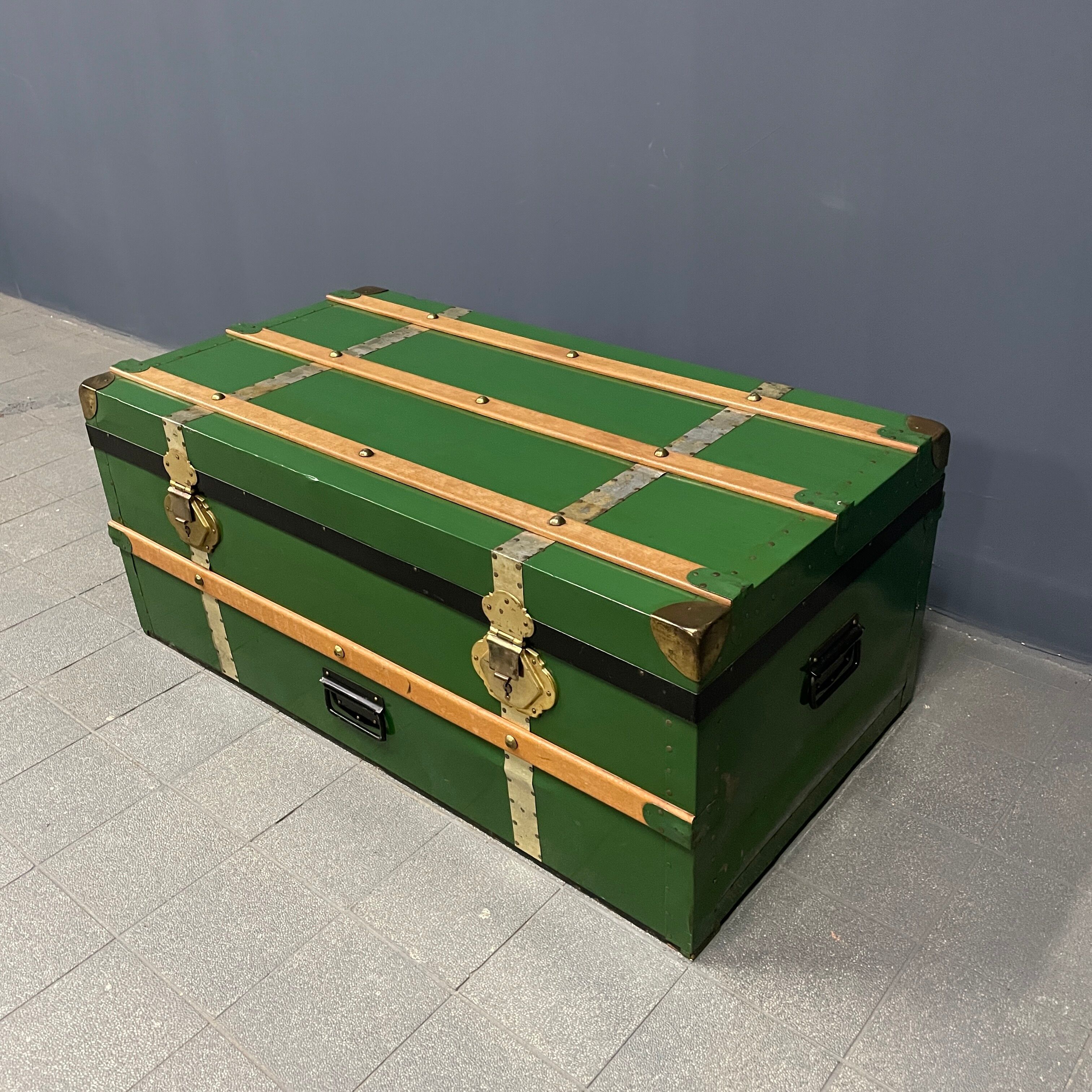 Green metal trunk with wooden sleds