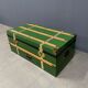 Green metal trunk with wooden sleds