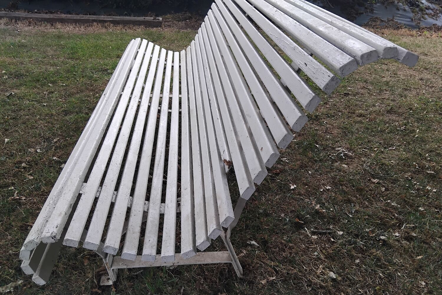 Old garden bench with metal legs and wooden slats