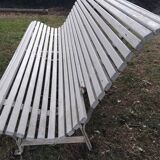 Old garden bench with metal legs and wooden slats