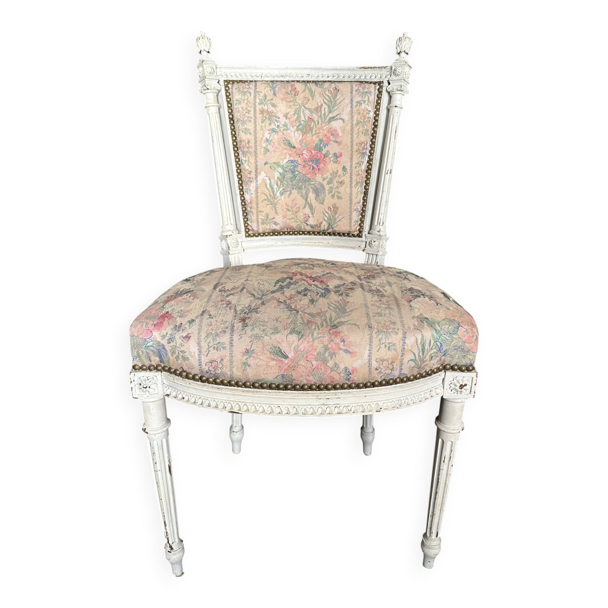 Antique Louis XVI style chair with patinated wood and floral fabric.