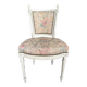 Antique Louis XVI style chair with patinated wood and floral fabric.