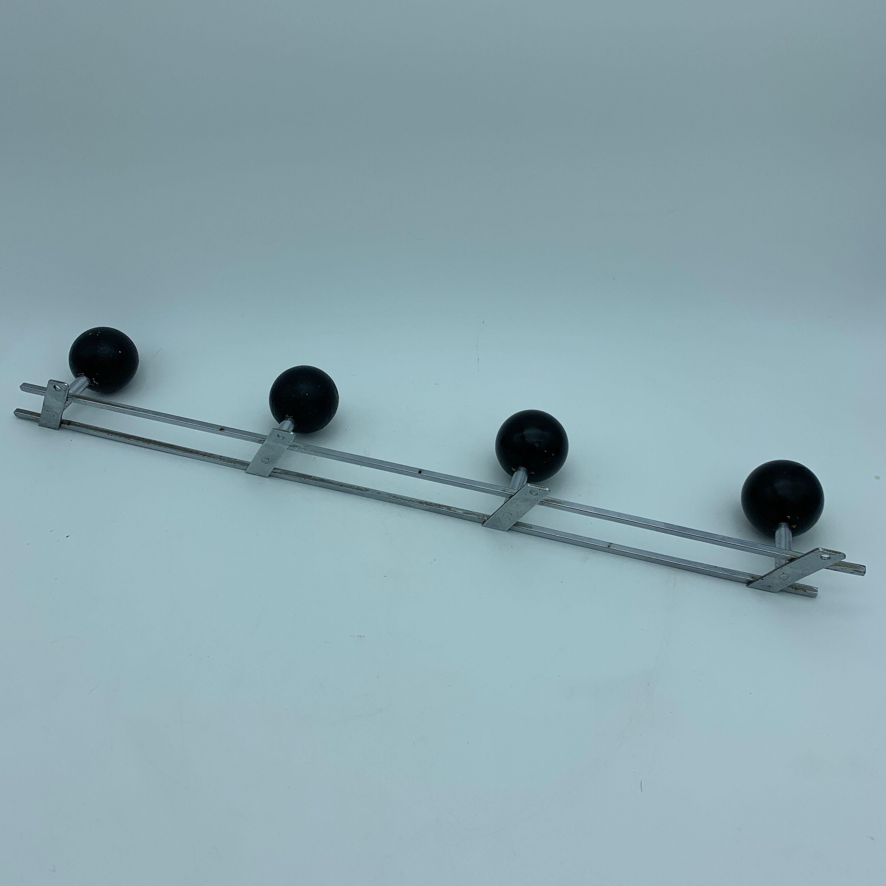 Coat holder 4 chrome steel pateres and black wooden balls