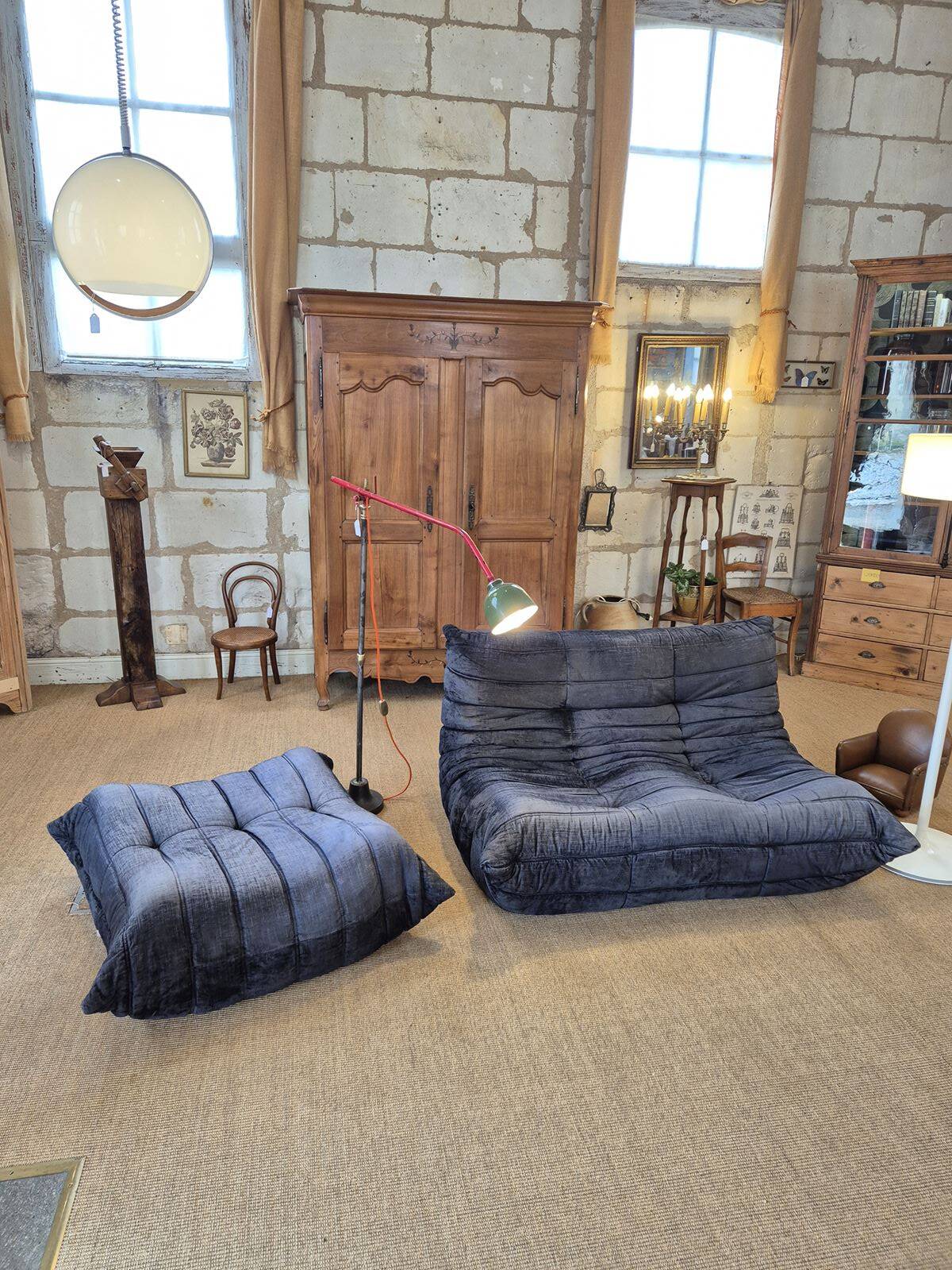 Togo sofa by Ligne Roset and its pouf from the 1970s.