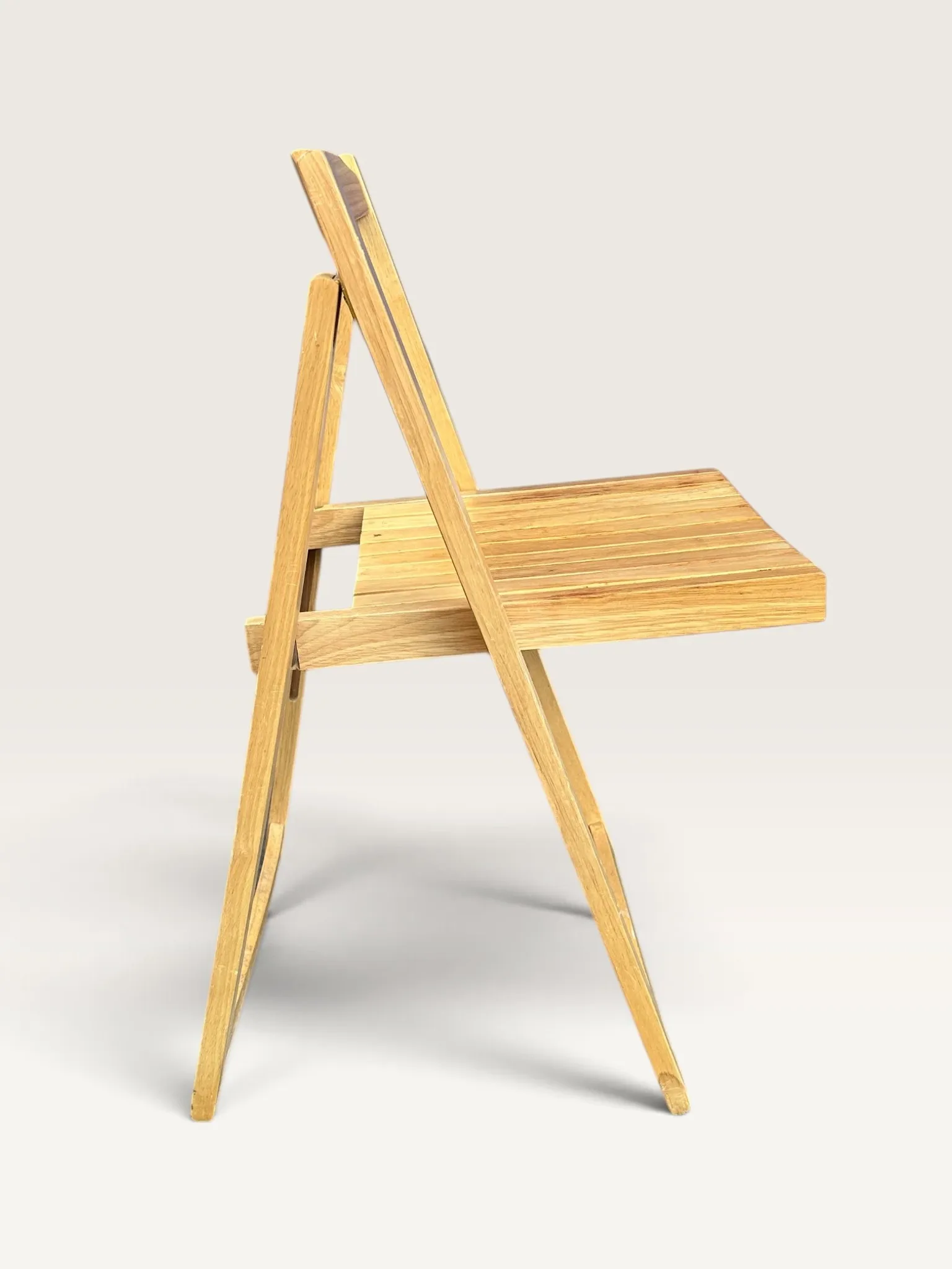 Blonde wooden folding chair in the style of Aldo Jacober.