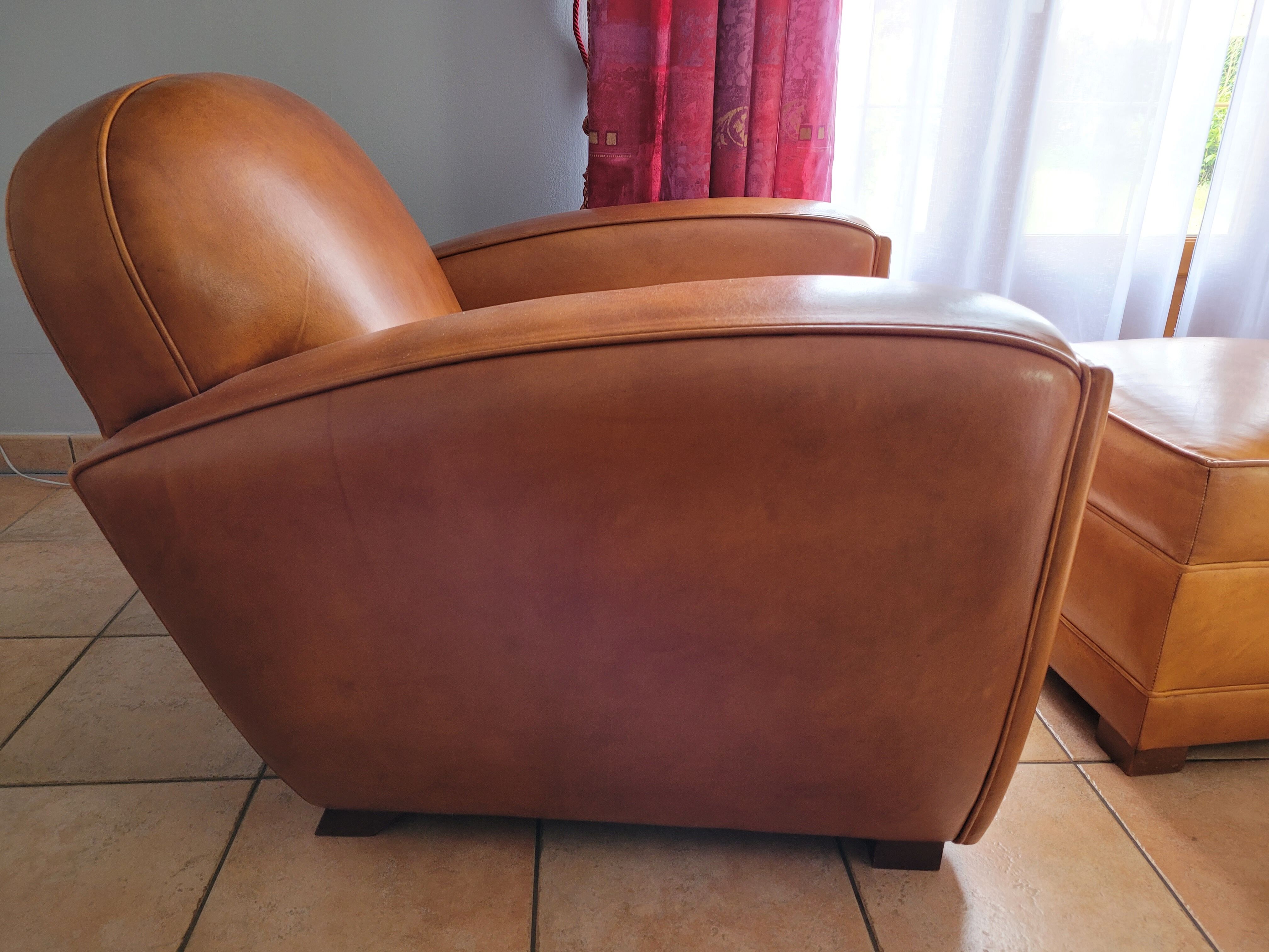 Leather club armchair and its pouf