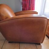 Leather club armchair and its pouf