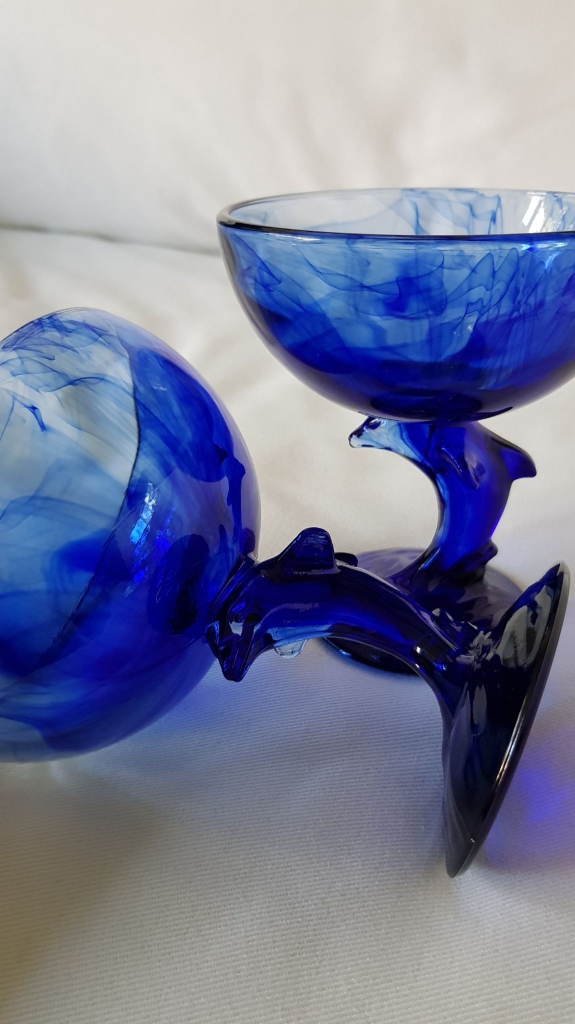 Set of 2 dolphin dessert cups in blue glass.