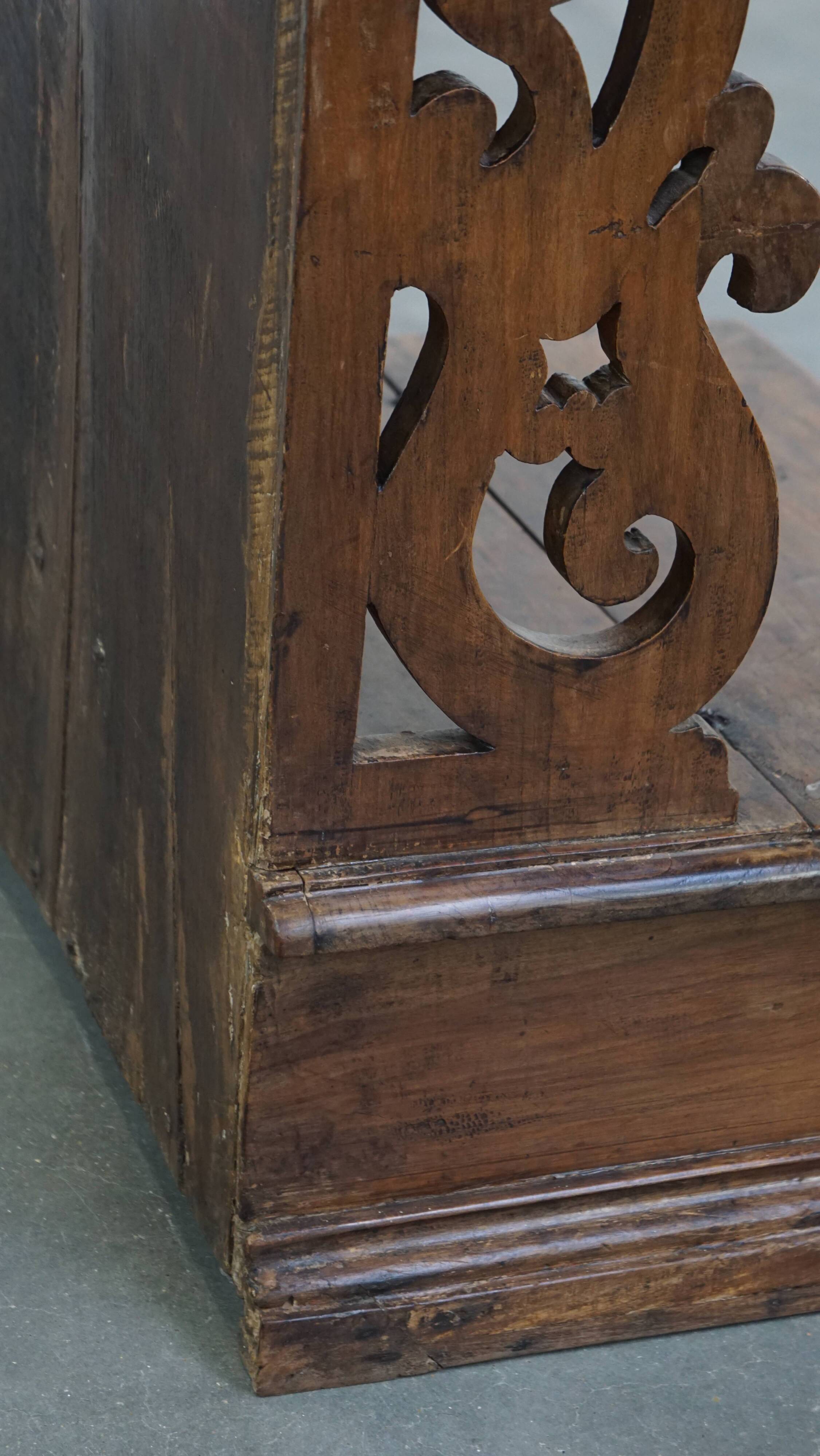 Antique pinewood church pew with storage compartments from the 18th century