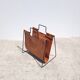 Magazine rack in tan leather and black metal