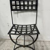 Set of four wrought iron chairs, with a reclining X-shaped base, seat and backrest.