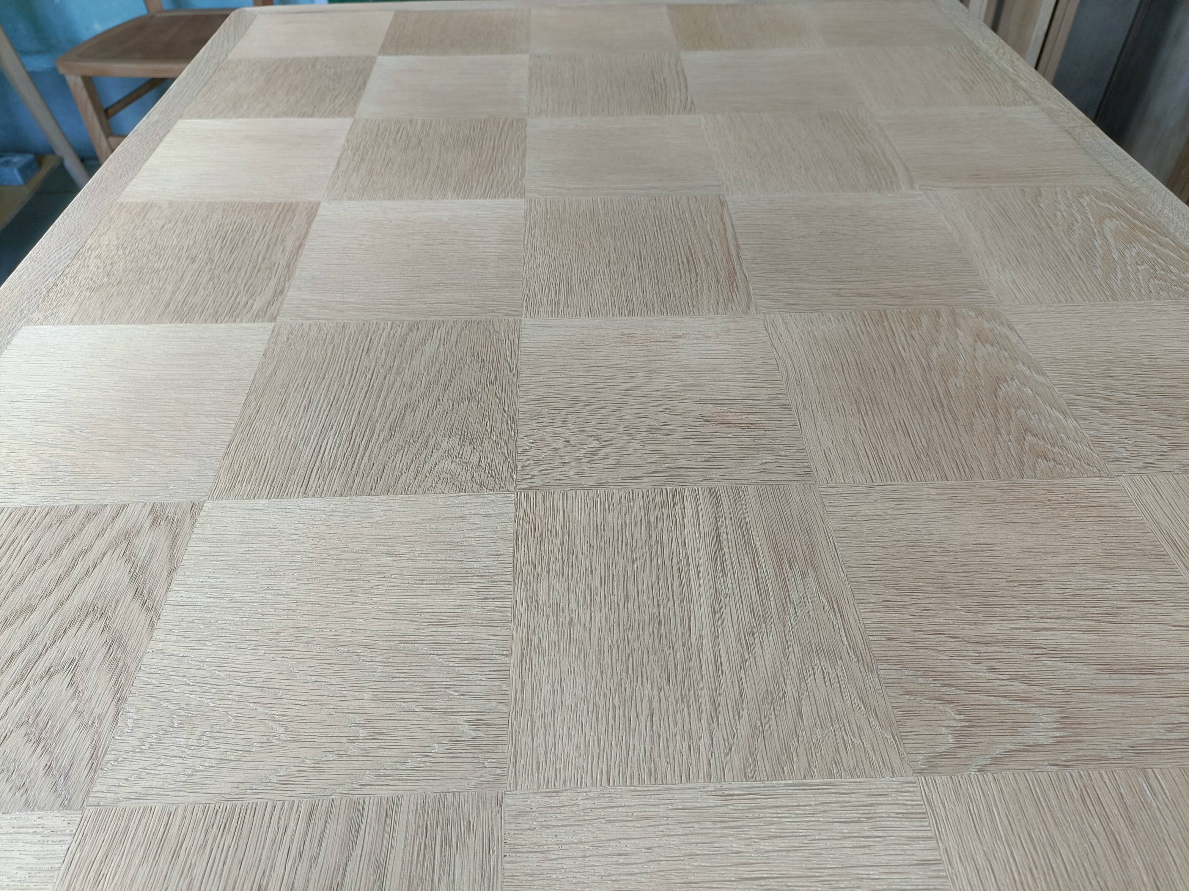 Oak dining table with a checkerboard top and extensions.