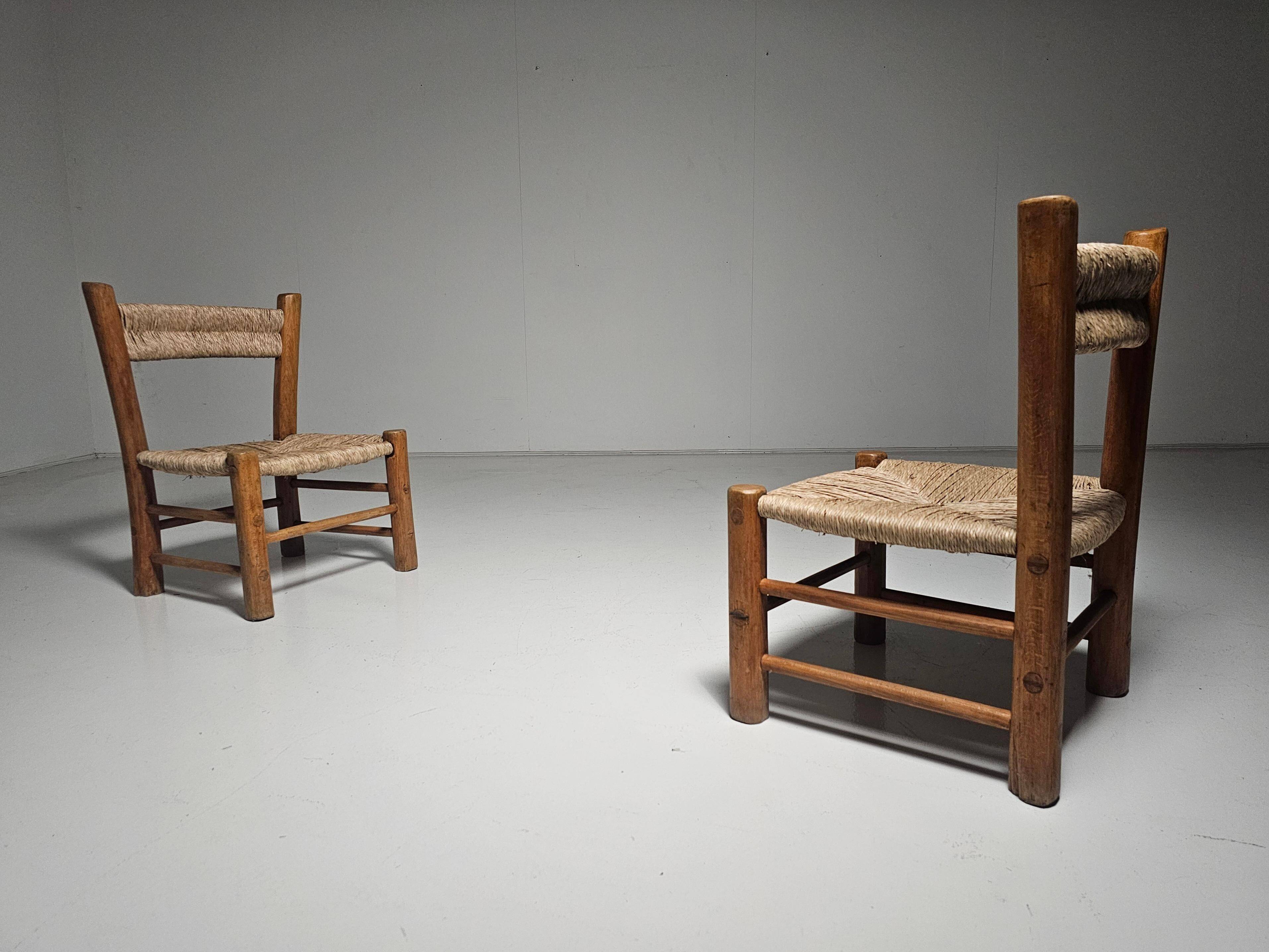 Pair of rustic French low chairs made of elm wood and straw, 1960s.