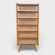 Vintage rattan chest of drawers with splayed legs from the 1950s.